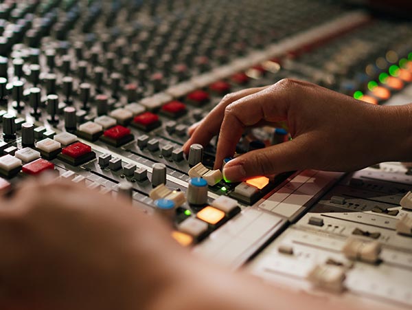 sae-liverpool-campus-cutting-edge-facilities A pair of hands working an audio desk.