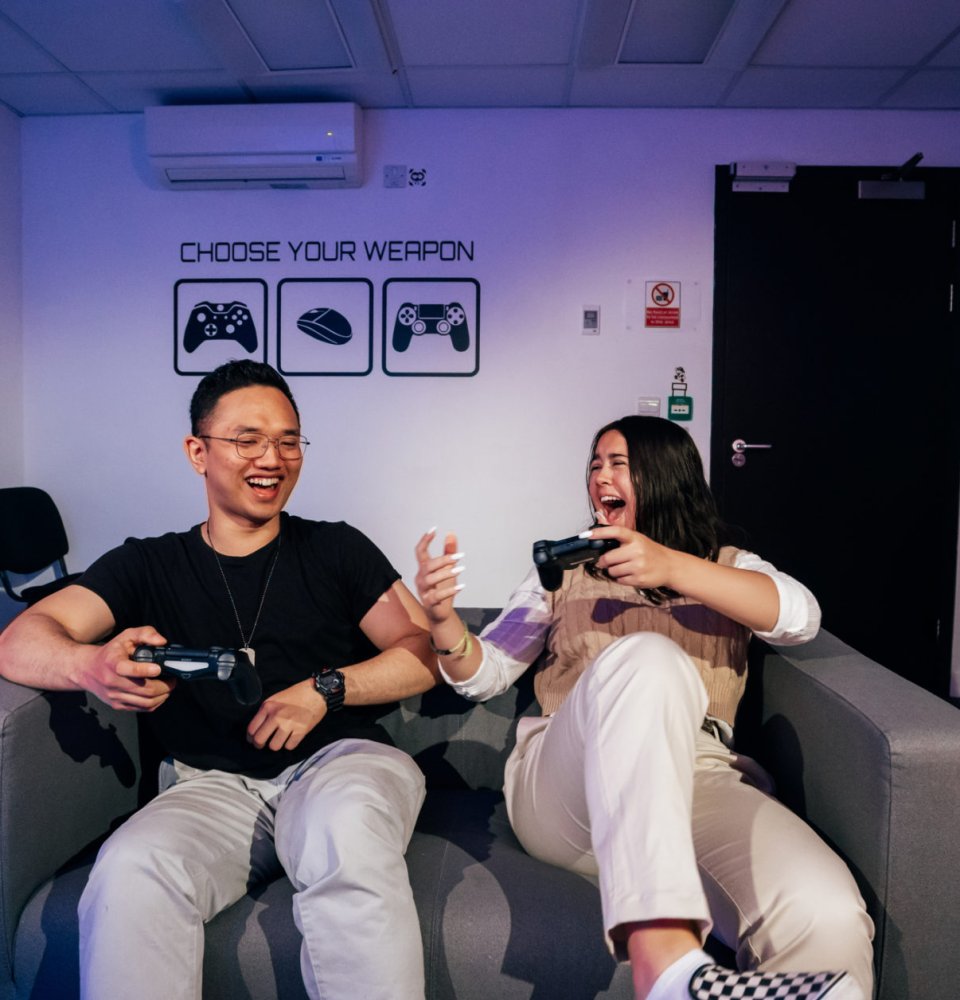 A pair of students having fun whilst playing games.